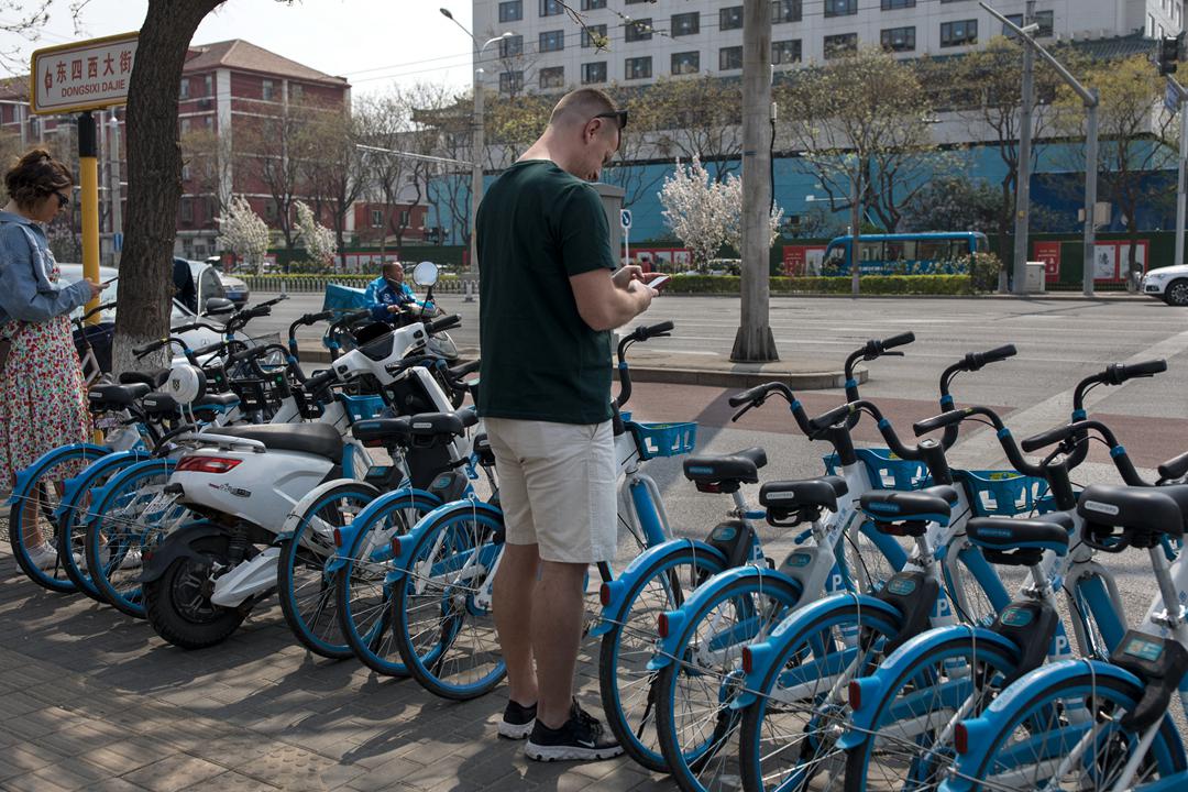 A tourist scans a code to ride a shared bike in April 2021 in Beijing. Photo: VCG